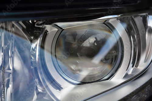New headlight of a modern car close up. Photo can be used as a background