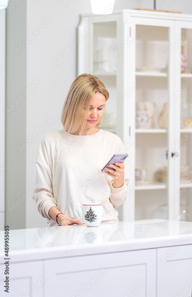 Young beautiful blonde girl at home in the kitchen Young beautiful blonde girl at home in the kitchen