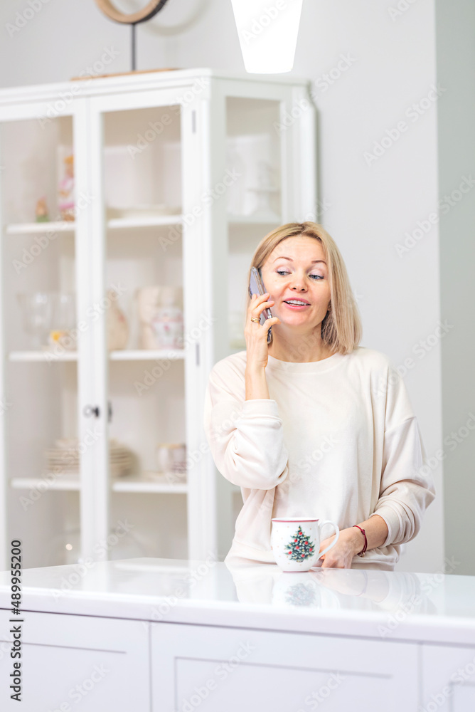 Young beautiful blonde girl at home in the kitchen Young beautiful blonde girl at home in the kitchen