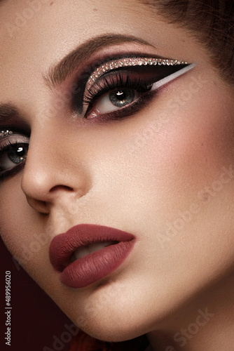 Portrait of a beautiful woman in a disco style image with creative makeup and hairstyle.