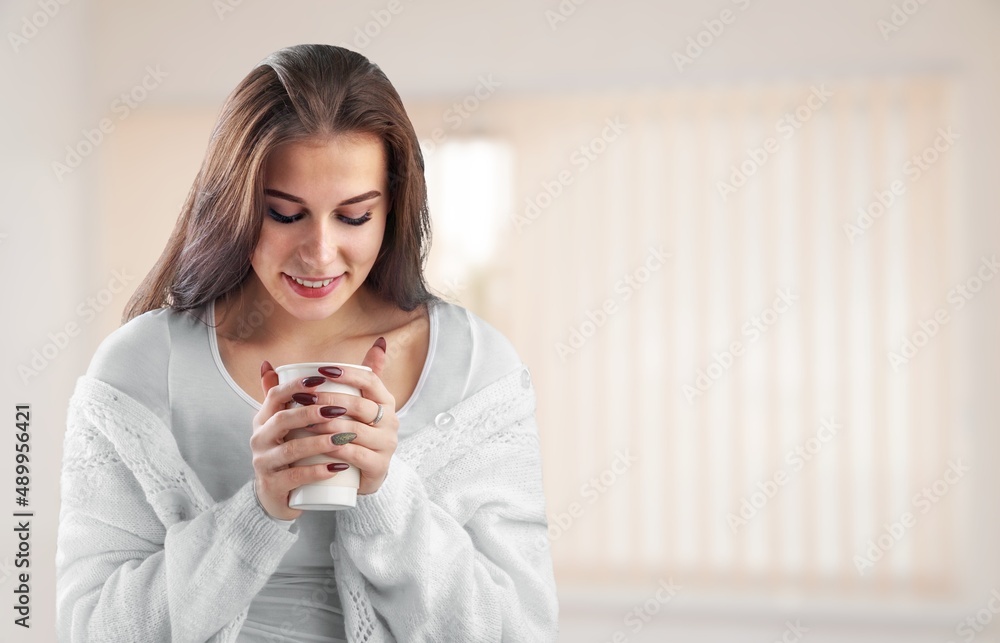 Relaxed woman smelling coffee in the morning sitting in the room at home Relaxed woman smelling coffee in the morning sitting in the room at home