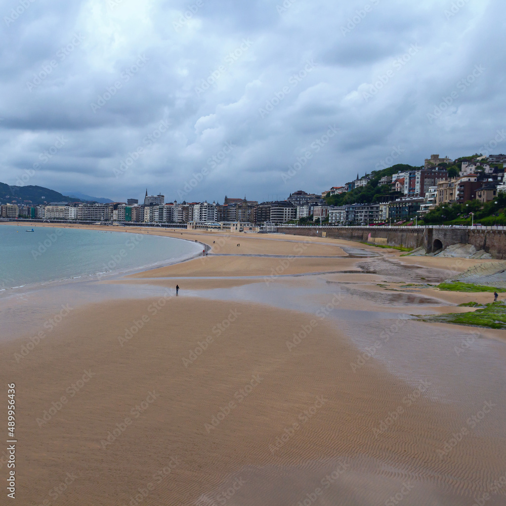 wide sandy beach, calm sea, cloudy sky. San Sebastian. Spain wide sandy beach, calm sea, cloudy sky. San Sebastian. Spain