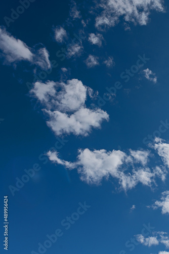 white cumulus clouds on blue sky as natural background