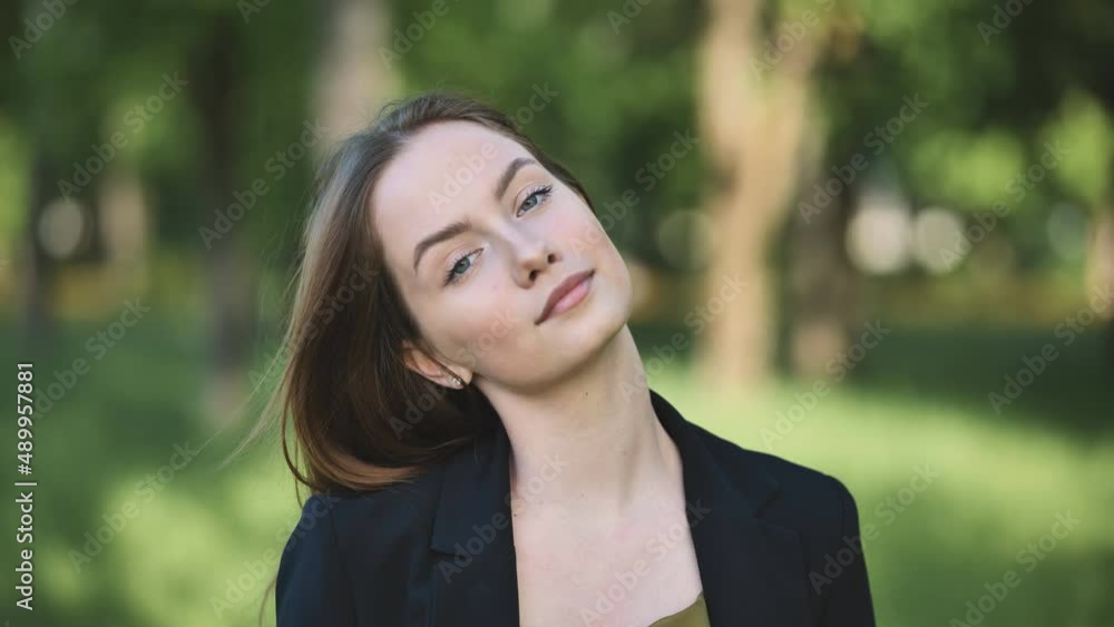 Portrait of a young business girl in a jacket in the park. Portrait of a young business girl in a jacket in the park.