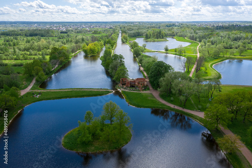 A panoramic view from a height of the ponds and the Landscape Park in Peterhof, the meadow garden, walking paths, the destroyed pavilion.