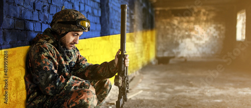 Obraz na plátně Military soldier on the background of the flag of Ukraine