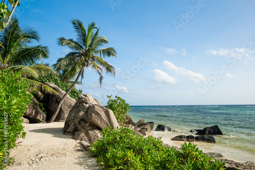 Anse Source d'Argent beach on La Digue island, Seychelles. Huge beautifully shaped boulders, rocks and palm trees - a heavenly beach and a tropical place to relax