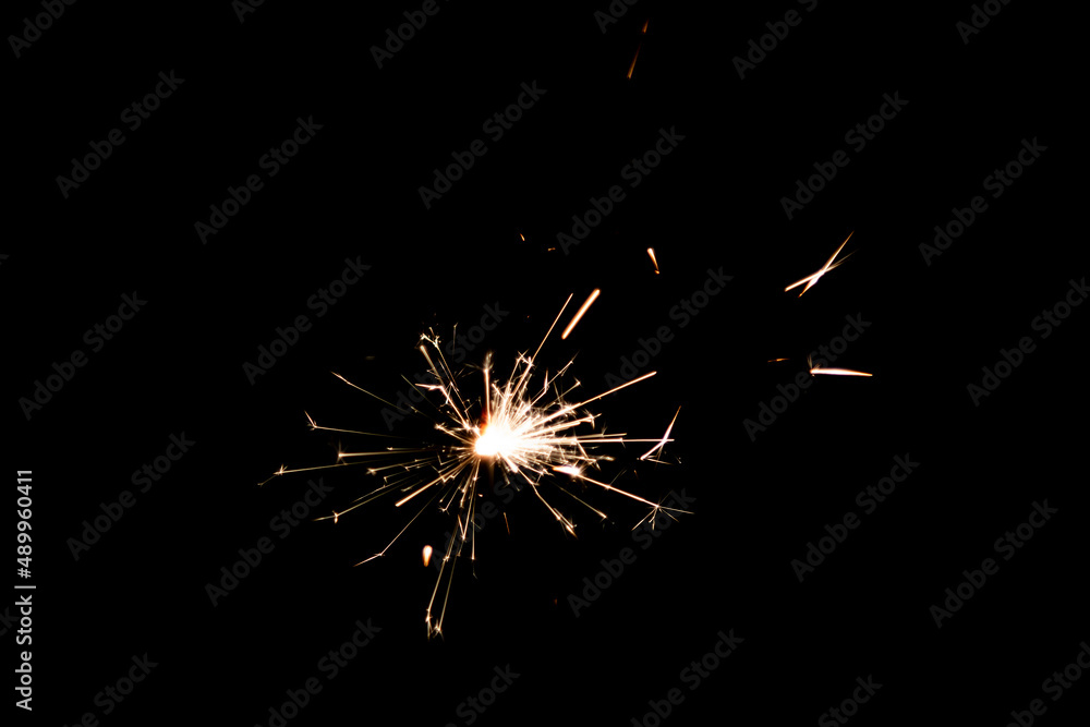 Burning sparkler isolated on black background. Fireworks theme. Light effect and texture. Burning sparkler isolated on black background. Fireworks theme. Light effect and texture.