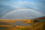 Panorama view of icelandic nature landscape. Rainbow after rain, road and river. West Iceland region