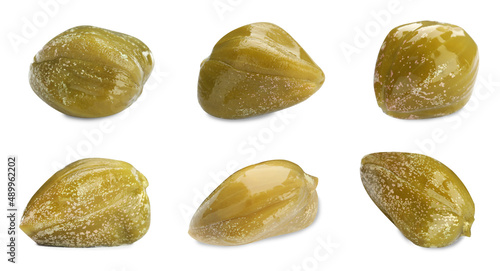 Foto Set with pickled capers on white background