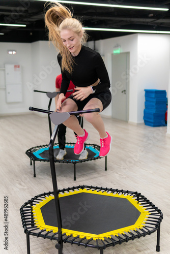 Women's and men's group on a sports trampoline, fitness training, healthy life - a concept trampoline group batut girl men, from lifestyle athletic for gym and teamwork motion, sportive sportswear photo