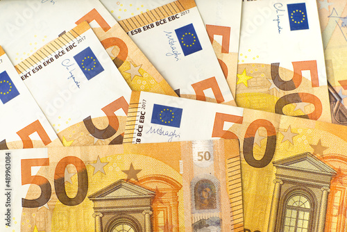 Flat lay pattern of 50 euro cash banknotes. Money background for financial and economy topics.
