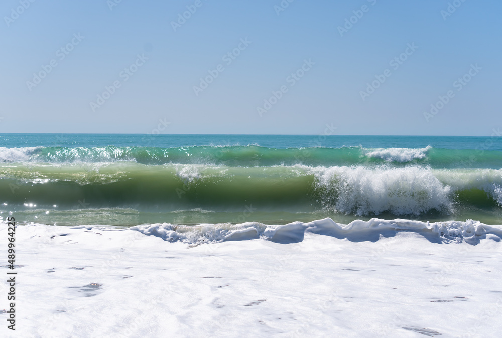 Fototapeta premium Beautiful blue sea and sky beyond white water from crashing and tumbling surf