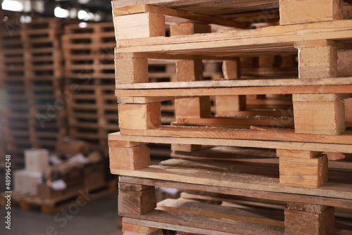Many empty wooden pallets stacked in warehouse  closeup
