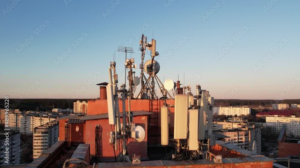 Group of telecommunication antenas on the on the roof of the building, satellite dishes and television antennas, mobile communication antennas, a radio relay dishes, blocks of the radio module Group of telecommunication antenas on the on the roof of the building, satellite dishes and television antennas, mobile communication antennas, a radio relay dishes, blocks of the radio module