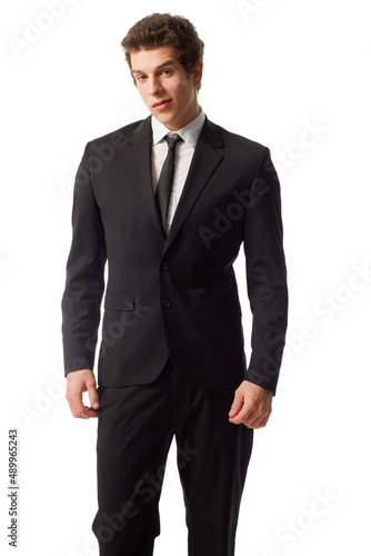 Young and confident. A confident young man standing in a suit against a white background.