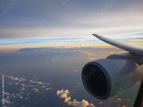 View from airplane window of sky in evening light with aircraft engine