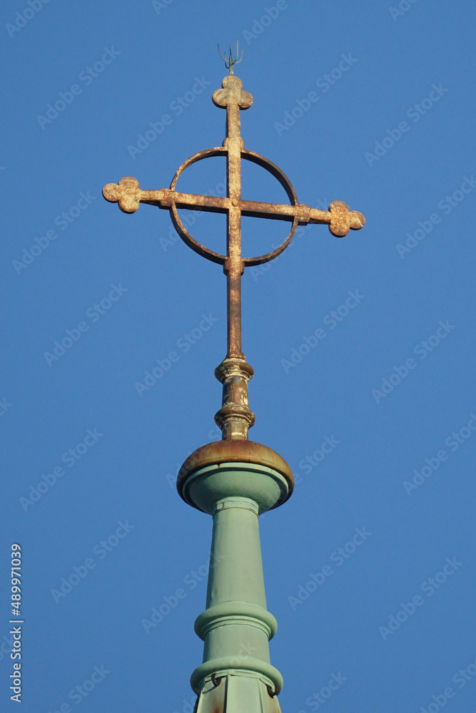 Cross with a circle on top of the church on the blue sky backgroung Cross with a circle on top of the church on the blue sky backgroung