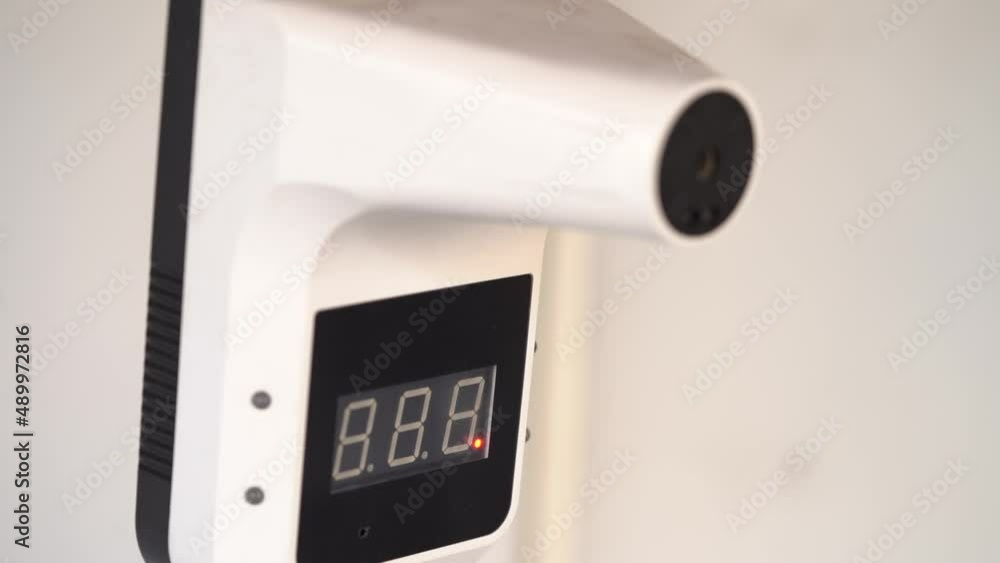 A Man Hand Check Body Temperature to Apply Covid 19 Regulation Via Temperature Screening, Close Up A Man Hand Check Body Temperature to Apply Covid 19 Regulation Via Temperature Screening, Close Up