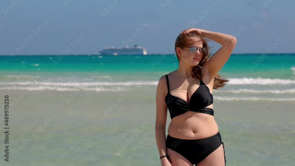 Young pretty woman wearing a bikini at Miami Beach on a windy day Young pretty woman wearing a bikini at Miami Beach on a windy day