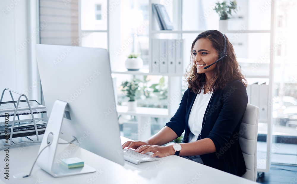 Answering every call with utmost professionalism. Shot of a young call centre agent working in an office. Answering every call with utmost professionalism. Shot of a young call centre agent working in an office.