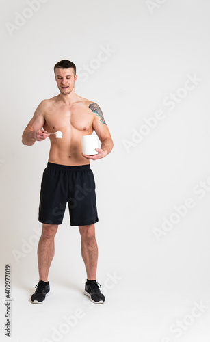 Fitness protein jars white on white background bodybuilder powder strong high back body injury, ill white young stress, hand sickness, ain suffer attractive © Ilya