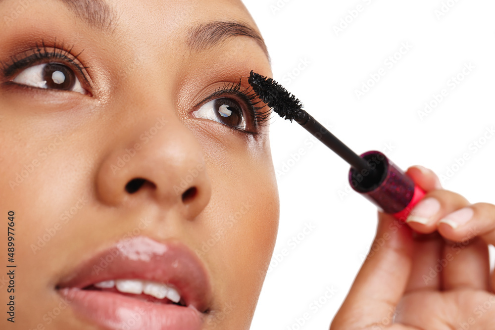 Artist at work. Cropped shot of a gorgeous young woman applying mascara in a studio-isolated on white.