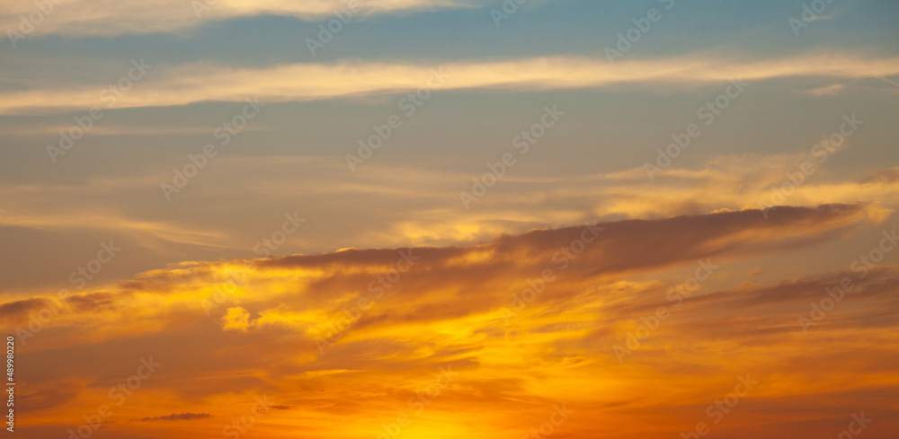 Golden sky at sunset. Concept of relaxation with natural scenery. Romantic mood.