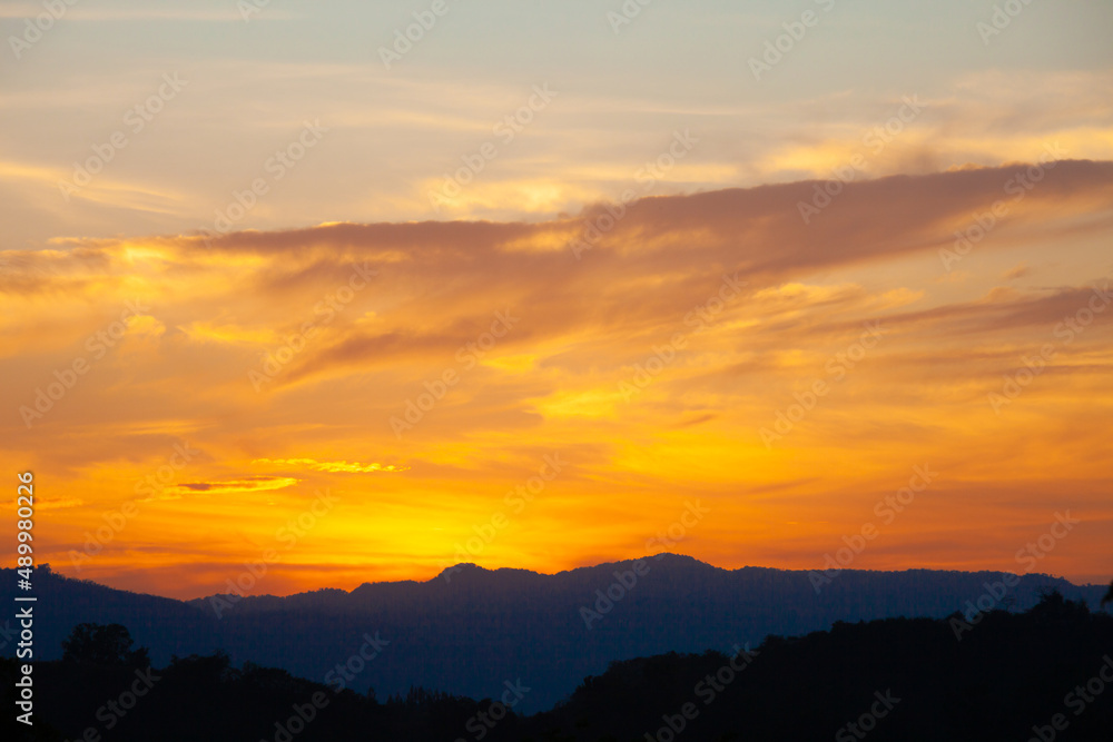 Golden sky at sunset. Concept of relaxation with natural scenery. Romantic mood.