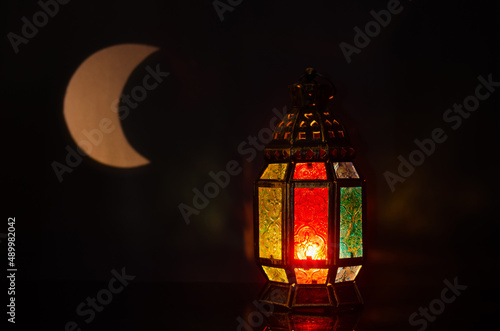 Lantern with moon shape from light on background for the Muslim feast of the holy month of Ramadan Kareem. © baramyou0708