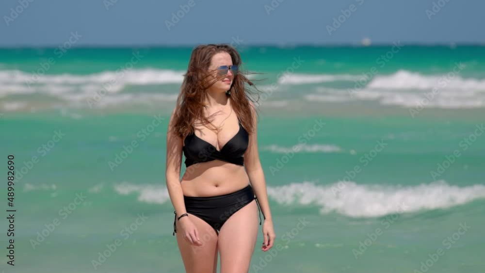 Young pretty woman wearing a bikini at Miami Beach on a windy day Young pretty woman wearing a bikini at Miami Beach on a windy day