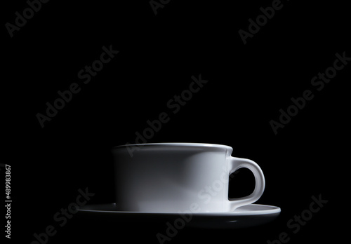 white ceramic cup coffee on a black background 