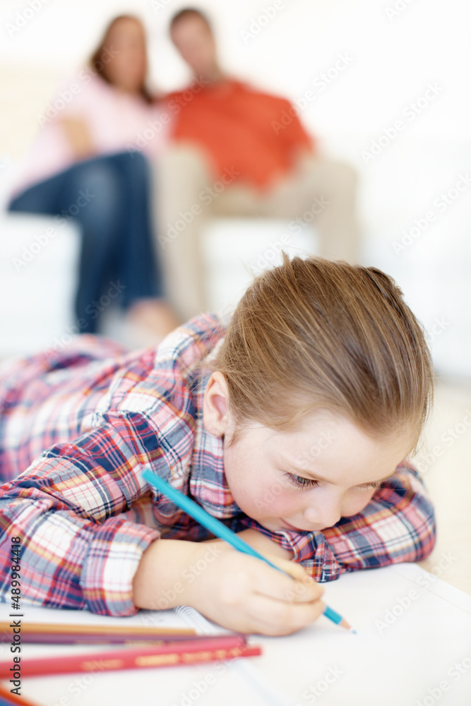 Im drawing a flower. A young girl lies on the floor and colours in. Im drawing a flower. A young girl lies on the floor and colours in.