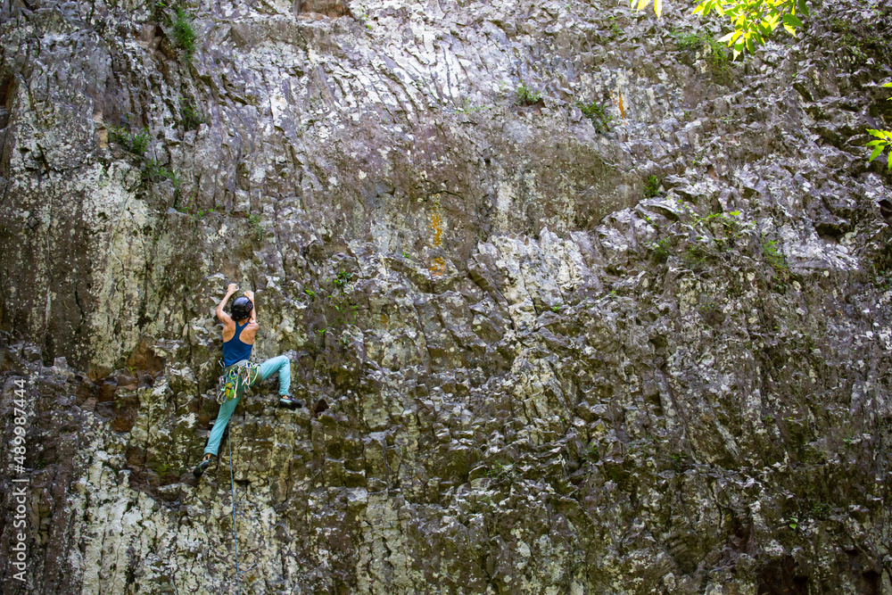 People climbing on a beautiful basaltic cliff in Reunion island People climbing on a beautiful basaltic cliff in Reunion island