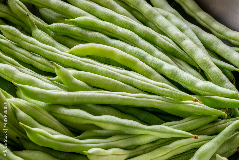 Close up organic string beans in kitchen bowl, fresh string beans with natural light.