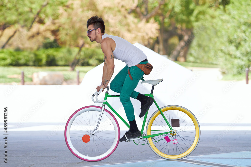 Bad ass biker. A handsome young man riding his bicycle outdoors. Bad ass biker. A handsome young man riding his bicycle outdoors.