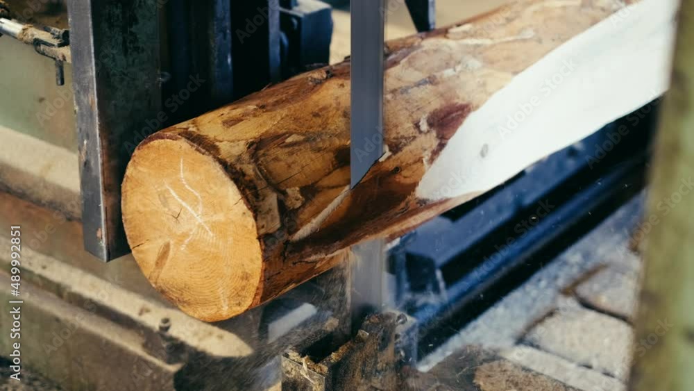 sawmill cutting. Processing and sawing timber at a sawmill. Industrial sawing of boards from logs. slow motion. 4K. Close up sawmill cutting. Processing and sawing timber at a sawmill. Industrial sawing of boards from logs. slow motion. 4K. Close up