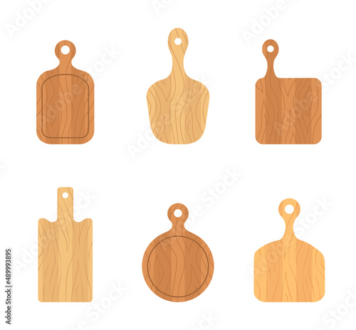 Set of wooden cutting boards. Kitchen tools of various shapes. Top view. Vector illustration in flat cartoon style.