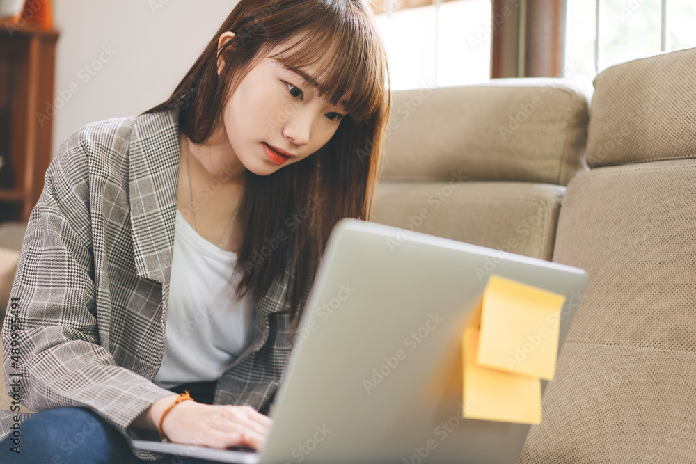 Young adult asian student woman learning at home indoor on day. Young adult asian student woman learning at home indoor on day.