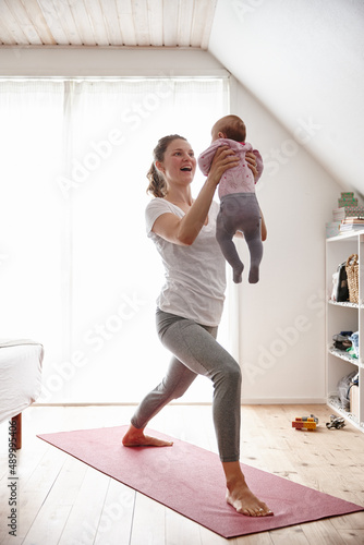 Body conscious mom and baby. Shot of an attractive young woman bonding with her baby girl while doing yoga.
