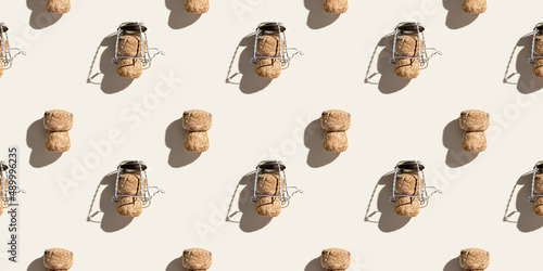 Creative pattern with champagne cork on beige background with hard light and shadows at sunlight. Minimal style layout with bottle cap from sparkling wine and muselet, top view wide banner