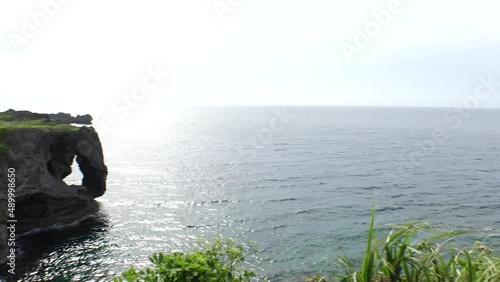 OKINAWA, JAPAN - AUG 2021 : View of sea and Cape Manzamo located near Onna son village in the Kunigami District. Wide view, real time shot in daytime. Summer holiday, vacation and resort concept video photo