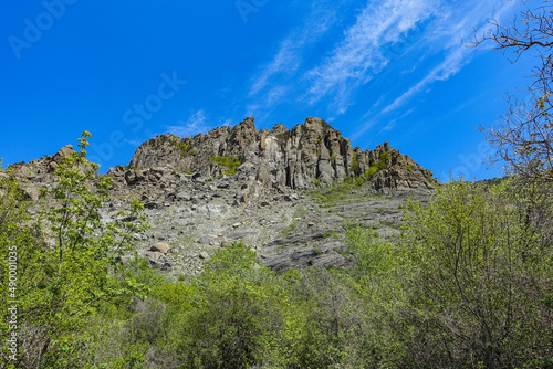 Ancient limestone high mountains in the air haze. The Valley of Ghosts. Demerji. May 2021 . Crimea. Russia