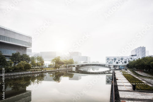 Photography Beautiful landscape abstract city blur background and The light of sun reflection building on water