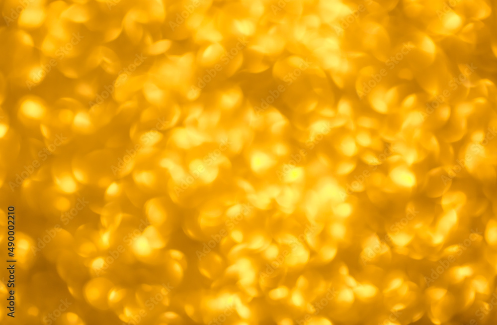 Blurred festive golden background. Bokeh background of yellow Christmas sparkles. Beautiful Christmas decoration of the interior of the house. Blurred festive golden background. Bokeh background of yellow Christmas sparkles. Beautiful Christmas decoration of the interior of the house.