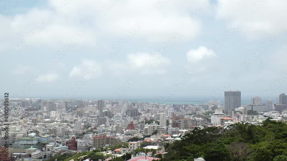NAHA, OKINAWA, JAPAN - AUGUST 2021 : Aerial high angle view of Naha city. Cityscape of downtown area and sunny blue sky. Time lapse shot in daytime. Summer holiday, vacation and travel concept video. NAHA, OKINAWA, JAPAN - AUGUST 2021 : Aerial high angle view of Naha city. Cityscape of downtown area and sunny blue sky. Time lapse shot in daytime. Summer holiday, vacation and travel concept video.