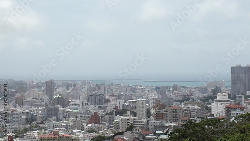 Wallpaper Mural NAHA, OKINAWA, JAPAN - AUG 2021 : Aerial high angle wide view of Naha city. Cityscape of downtown area and sunny blue sky. Time lapse shot in daytime. Summer holiday, vacation and travel concept video Torontodigital.ca