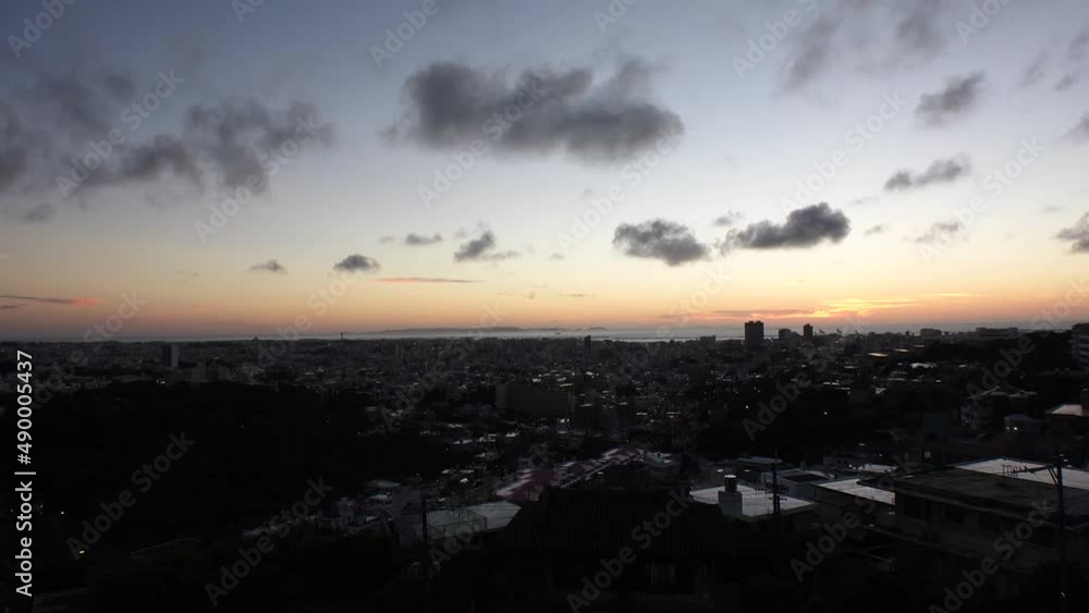 NAHA, OKINAWA, JAPAN - AUG 2021 : Aerial view of Naha city in sunset. Cityscape of downtown area. High angle wide view, time lapse shot dusk to night. Summer holiday, vacation and travel concept video NAHA, OKINAWA, JAPAN - AUG 2021 : Aerial view of Naha city in sunset. Cityscape of downtown area. High angle wide view, time lapse shot dusk to night. Summer holiday, vacation and travel concept video