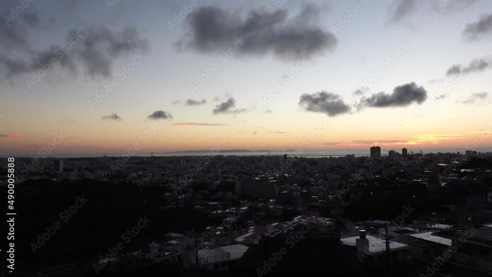 NAHA, OKINAWA, JAPAN - AUG 2021 : Aerial view of Naha city in sunset. Cityscape of downtown area. High angle wide view, time lapse shot dusk to night. Summer holiday, vacation and travel concept video NAHA, OKINAWA, JAPAN - AUG 2021 : Aerial view of Naha city in sunset. Cityscape of downtown area. High angle wide view, time lapse shot dusk to night. Summer holiday, vacation and travel concept video
