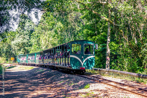 Argentina, Iguazu, June 07, 2019: Train between stations inside the Puerto Iguazu national park, Argentina. Tourists cross a forest on a train that leads to the falls photo